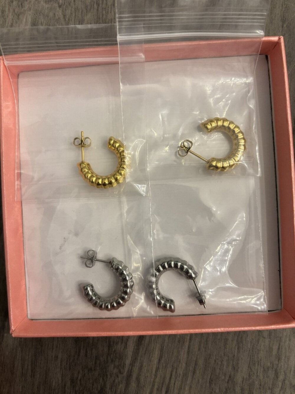 Hoop Earrings. One pair gold colored and one silver. New